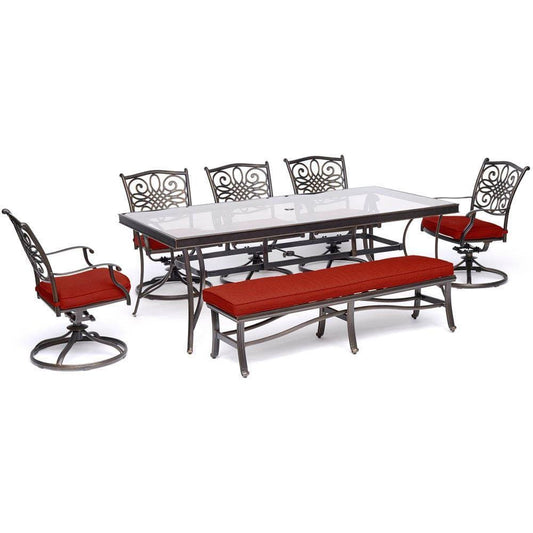 Hanover Outdoor Dining Set Hanover - Traditions 7-Piece Outdoor Dining Set in Red with 5 Swivel Rockers, a Cushioned Bench, and a 42" x 84" Glass-Top Table - TRADDN7PCSW5GBN-RED