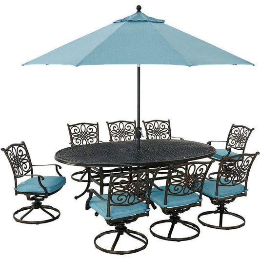 Hanover Outdoor Dining Set Hanover Traditions 9-Piece Dining Set in Blue with 8 Swivel Rockers, 95-in. x 60-in. Oval Cast-Top Table, Umbrella and Umbrella Stand