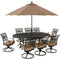 Hanover Outdoor Dining Set Hanover Traditions 9-Piece Dining Set in Tan with 8 Swivel Rockers, 95-in. x 60-in. Oval Cast-Top Table, Umbrella and Umbrella Stand