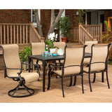 Hanover Outdoor Dining Set Hanover Brigantine 7 Piece Dining Set with a 40" x 70" Cast-Top Dining Table, 2 Sling Swivel Rockers, and 4 Sling Dining Chairs - Cast/Tan - BRIGDN7PCSW-2