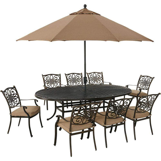 Hanover Outdoor Dining Set Hanover Traditions 9-Piece Dining Set in Tan with 8 Dining Chairs, 95-in. x 60-in. Oval Cast-Top Table, Umbrella and Stand