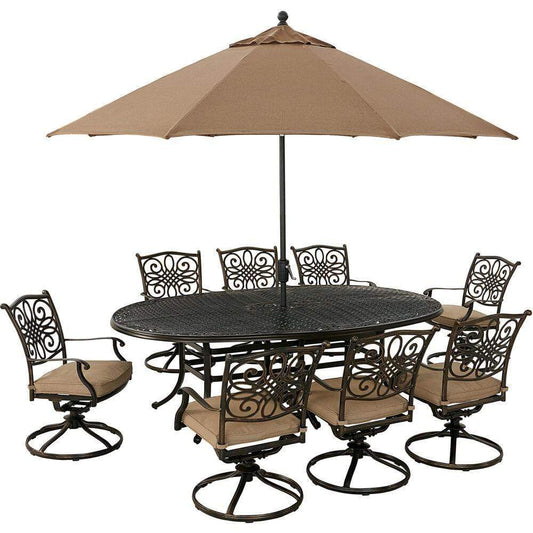 Hanover Outdoor Dining Set Hanover Traditions 9-Piece Dining Set in Tan with 8 Swivel Rockers, 95-in. x 60-in. Oval Cast-Top Table, Umbrella and Umbrella Stand