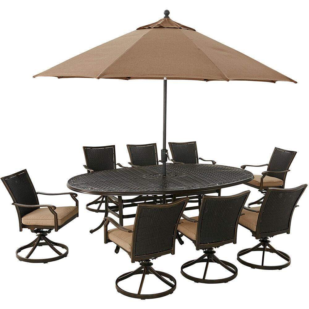 Hanover Outdoor Dining Set Hanover Traditions 9-Piece Set in Tan with 8 Wicker Back Swivel Rockers, 95-in. x 60-in. Oval Cast Dining Table, Umbrella and Stand
