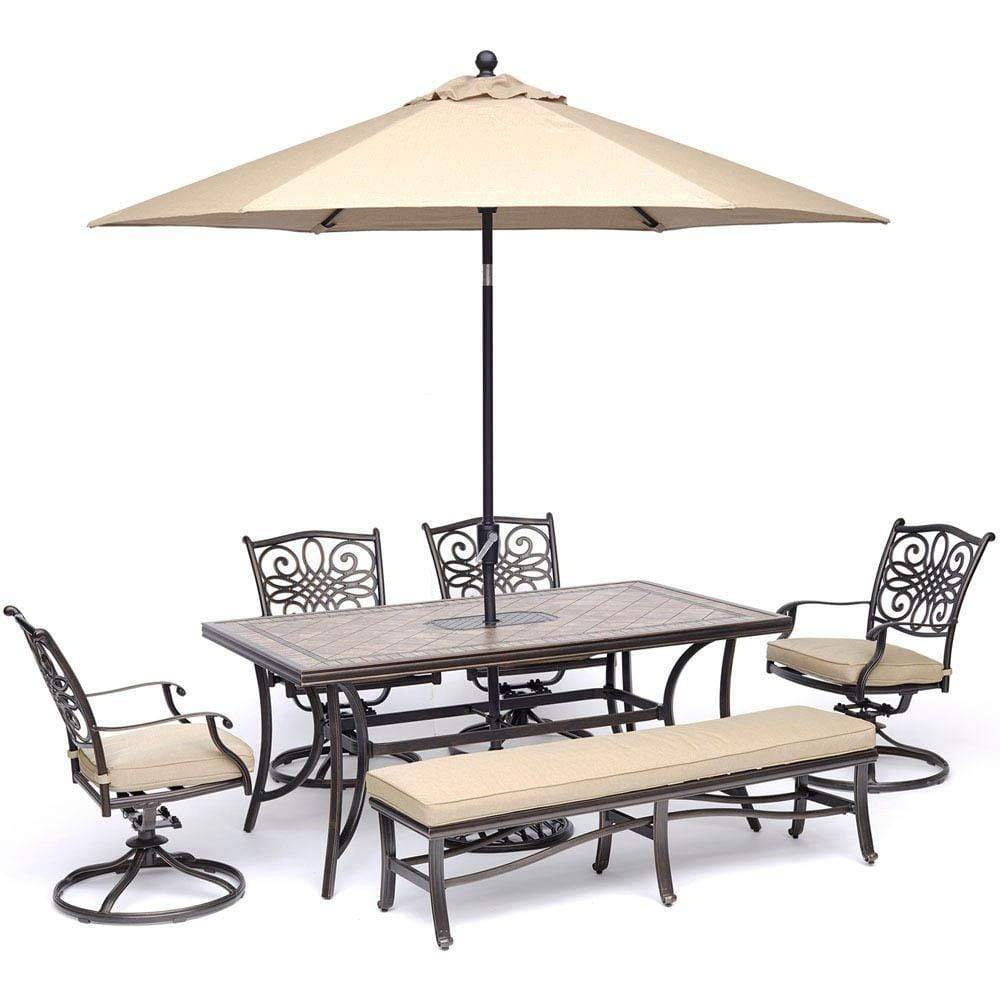 Hanover Table Umbrellas Hanover - Monaco 6-Piece Dining Set in Tan with 4 Swivel Rockers, 1 Bench, a 40" x 68" Tile-Top Table, and a 9 Ft. Umbrella with Stand